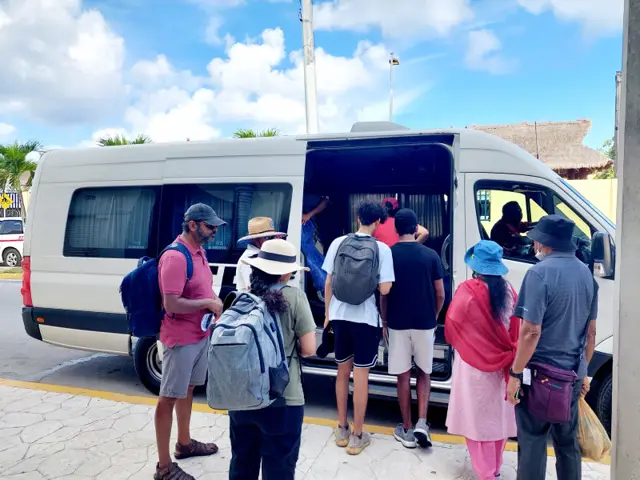 Guests climbing into a Cozumel Island Transfers van on the street