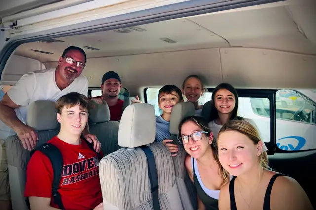 A family of eight, grandparents to small children, in one private van