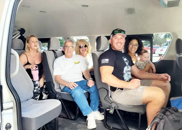 Three generations and a baby seated in a Cozumel Island Transfers van, plenty of room between the seats
